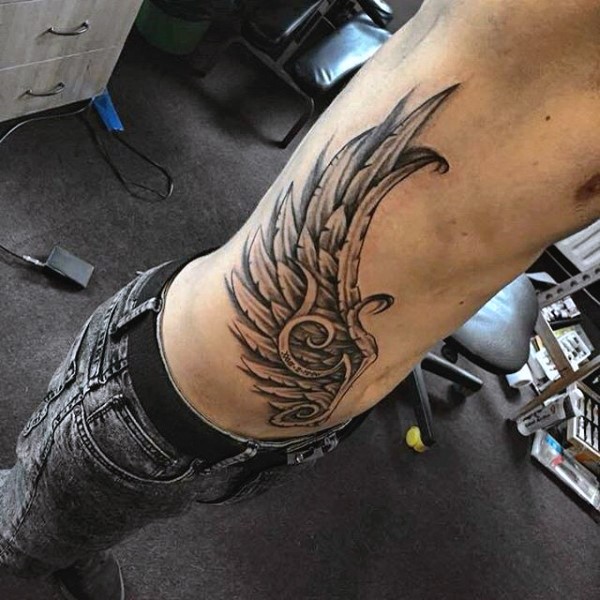 Little black and white fantasy wing tattoo on side