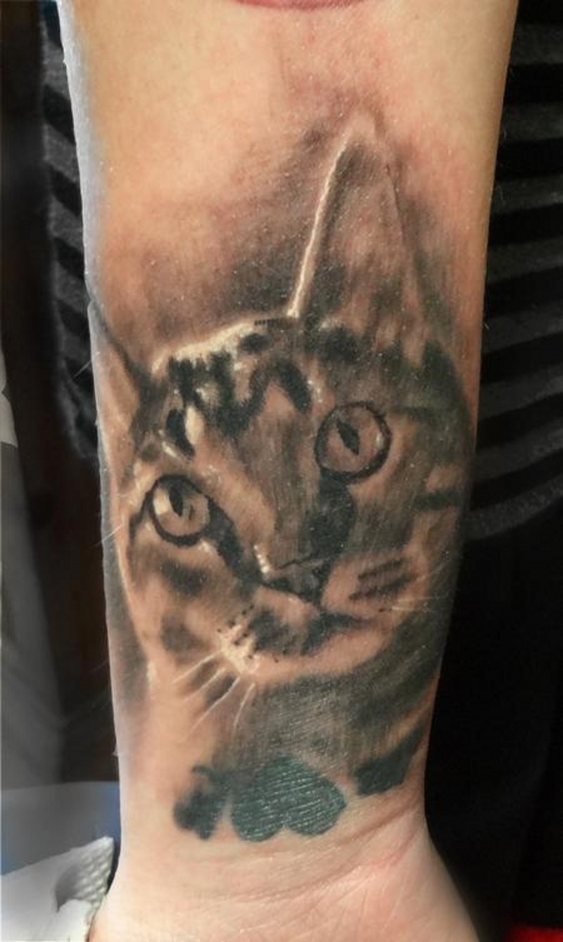 Little black and white forearm tattoo of cat portrait
