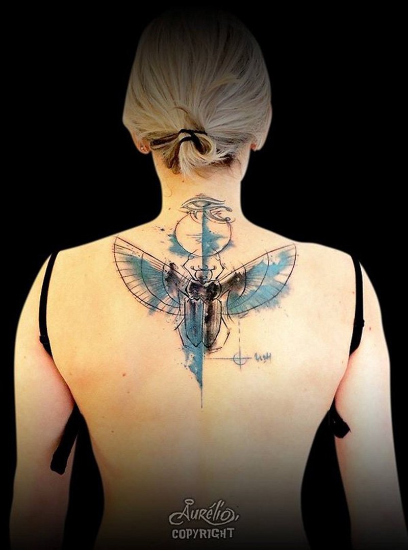 Little black and white mystical figure with wings tattoo on upper back