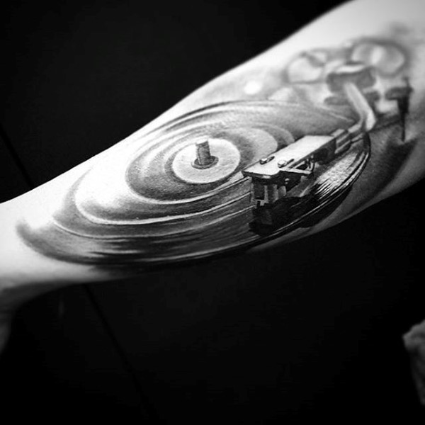 Little black and white old vinyl records player tattoo on arm