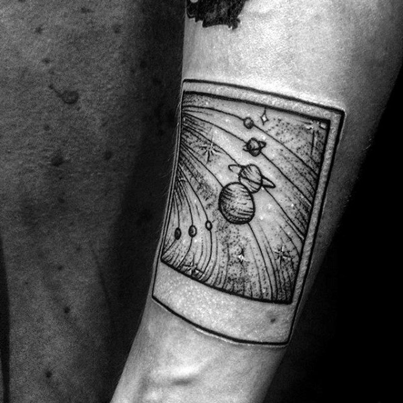 Little black and white photo like solar system tattoo on arm