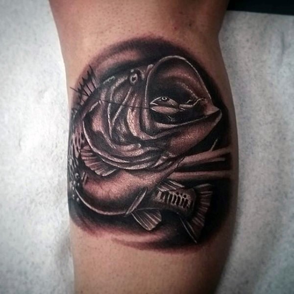 Little black and white realistic hooked fish tattoo on leg