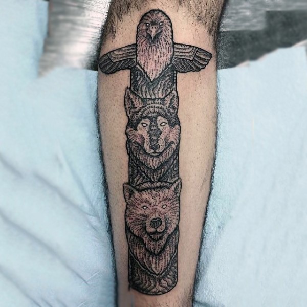 Little black and white tribal statue tattoo on arm