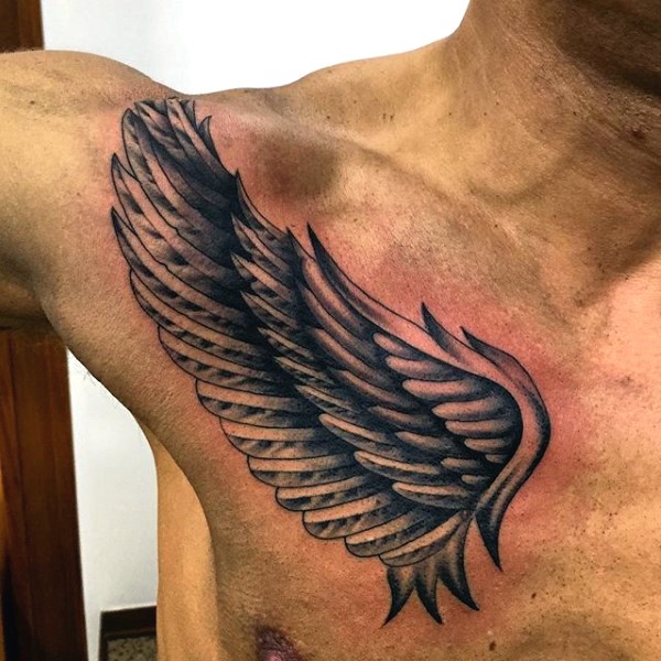 Little black and white wing on chest tattoo