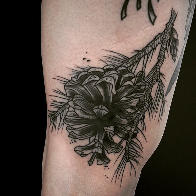 Little black ink fir-cone tattoo on arm zone