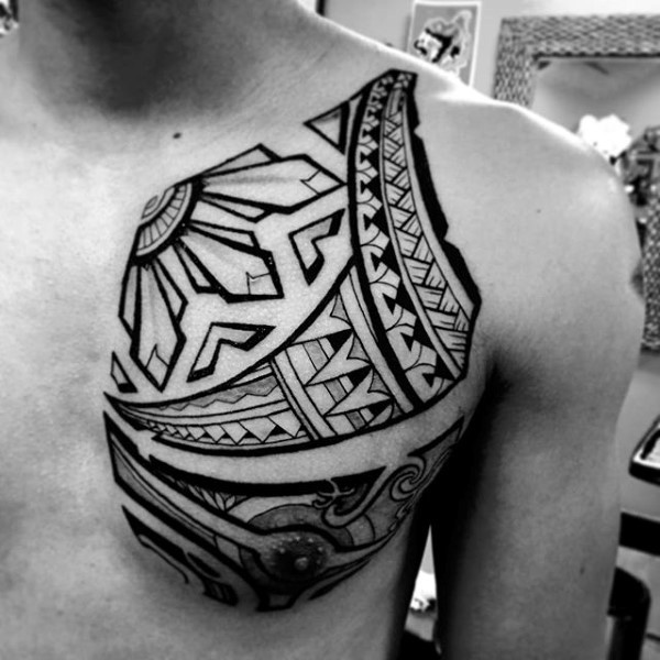 Little black ink geometrical tattoo on chest