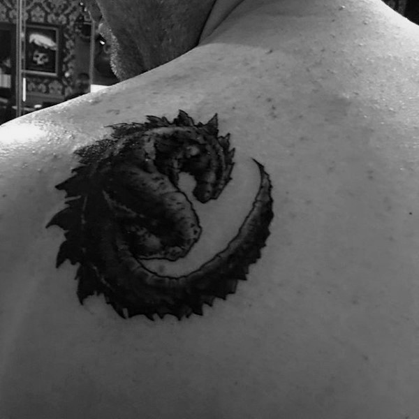 Little black ink Godzilla tattoo on shoulder
