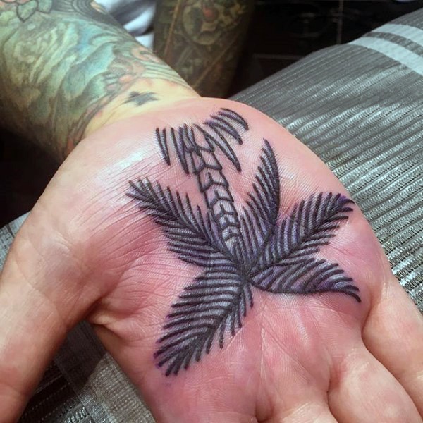 Little black ink homemade palm tree tattoo on hand
