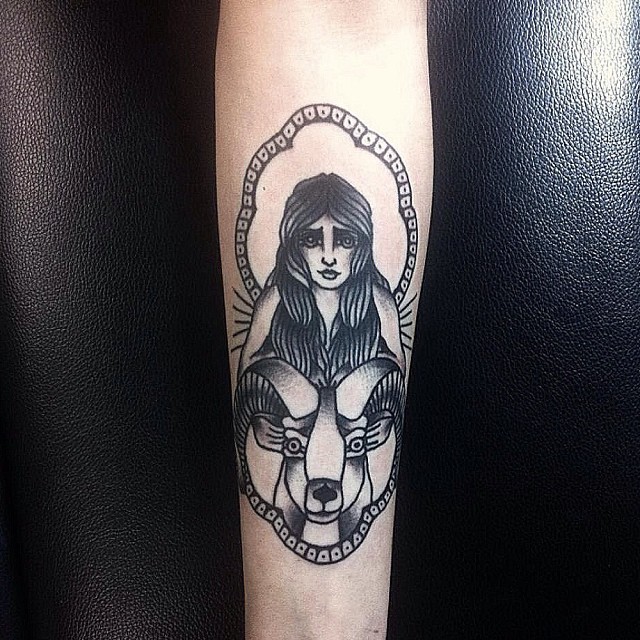 Little black ink old school woman tattoo on forearm combined with goat head