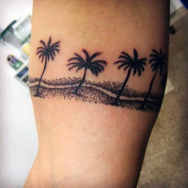 Little black ink palm trees tattoo on leg