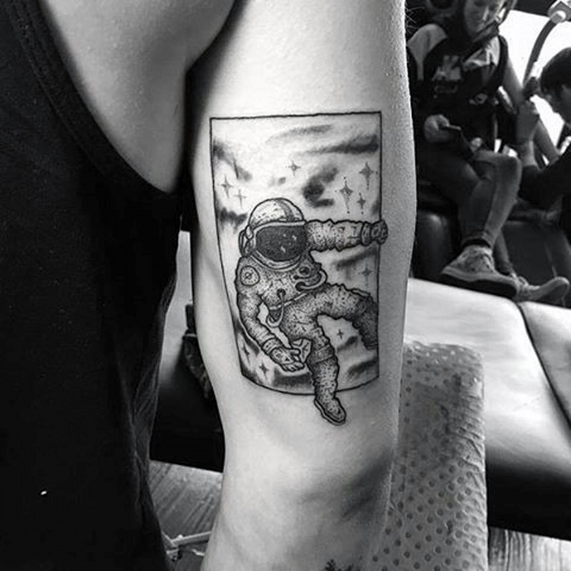 Little black ink photo like spaceman tattoo on arm