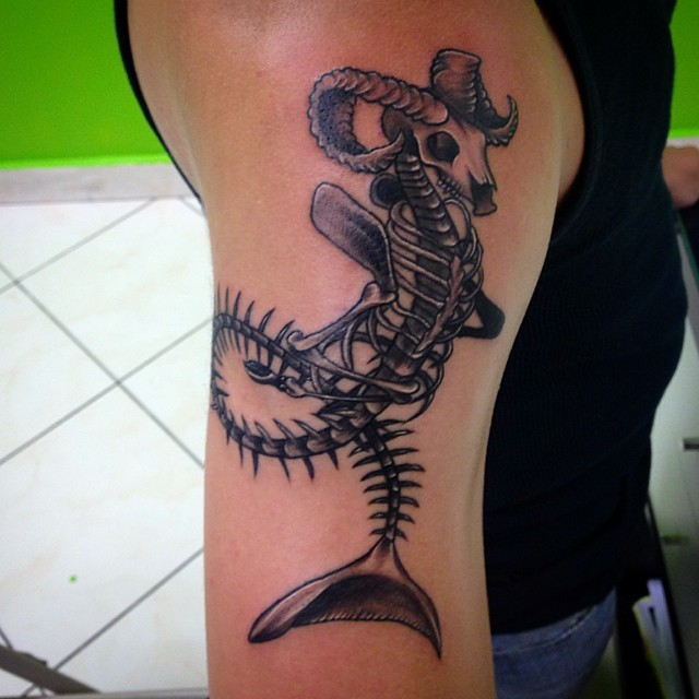 Little black ink shoulder tattoo of alien skeleton