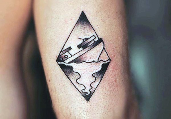 Little black ink sinking ship tattoo on arm