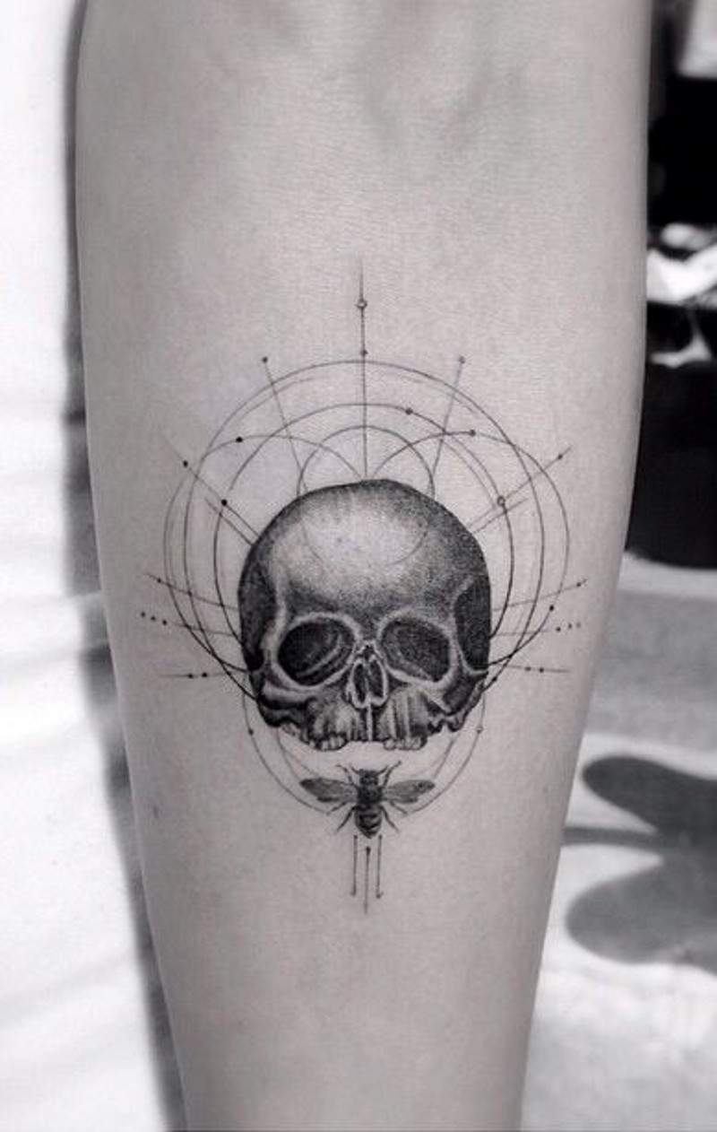 Little black ink skull with circles and insect tattoo on arm