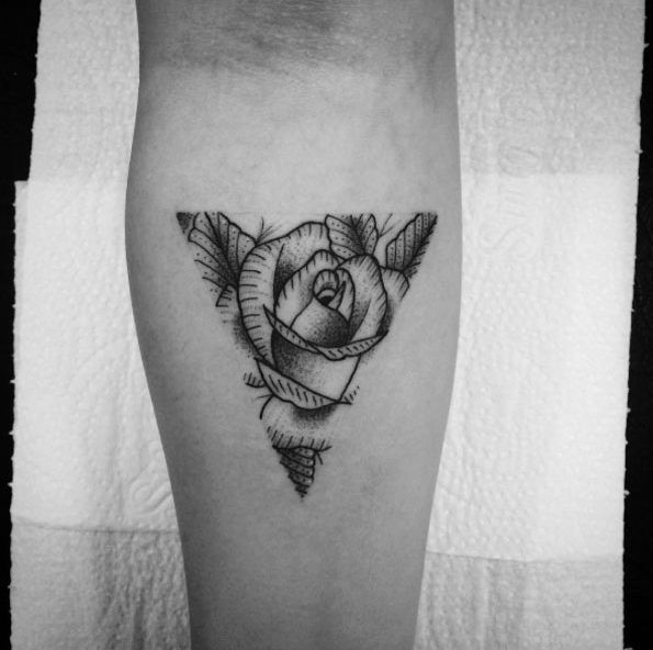 Little black ink triangle shaped tattoo on forearm stylized with rose flower