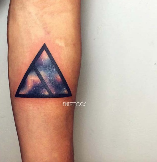 Little black ink triangle tattoo on forearm stylized with space