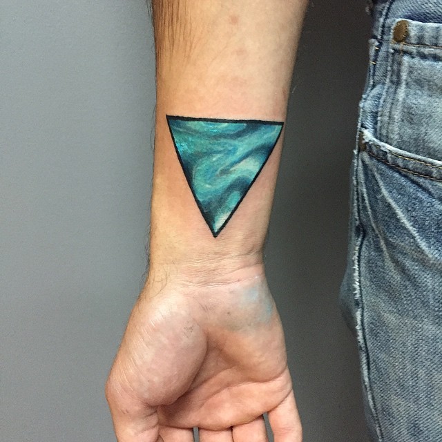 Little blue colored mysterious triangle tattoo on wrist