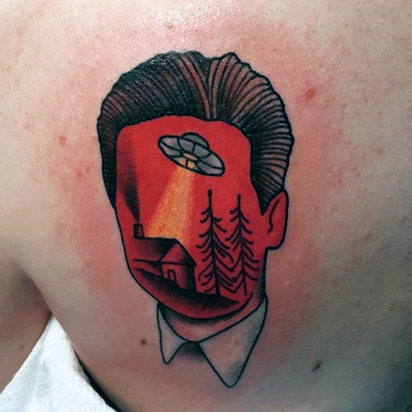 Little cartoon like colored mystical portrait with alien ship tattoo on back