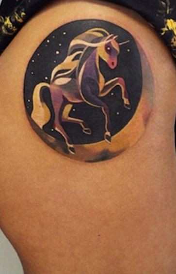 Little circle shaped thigh tattoo of space unicorn
