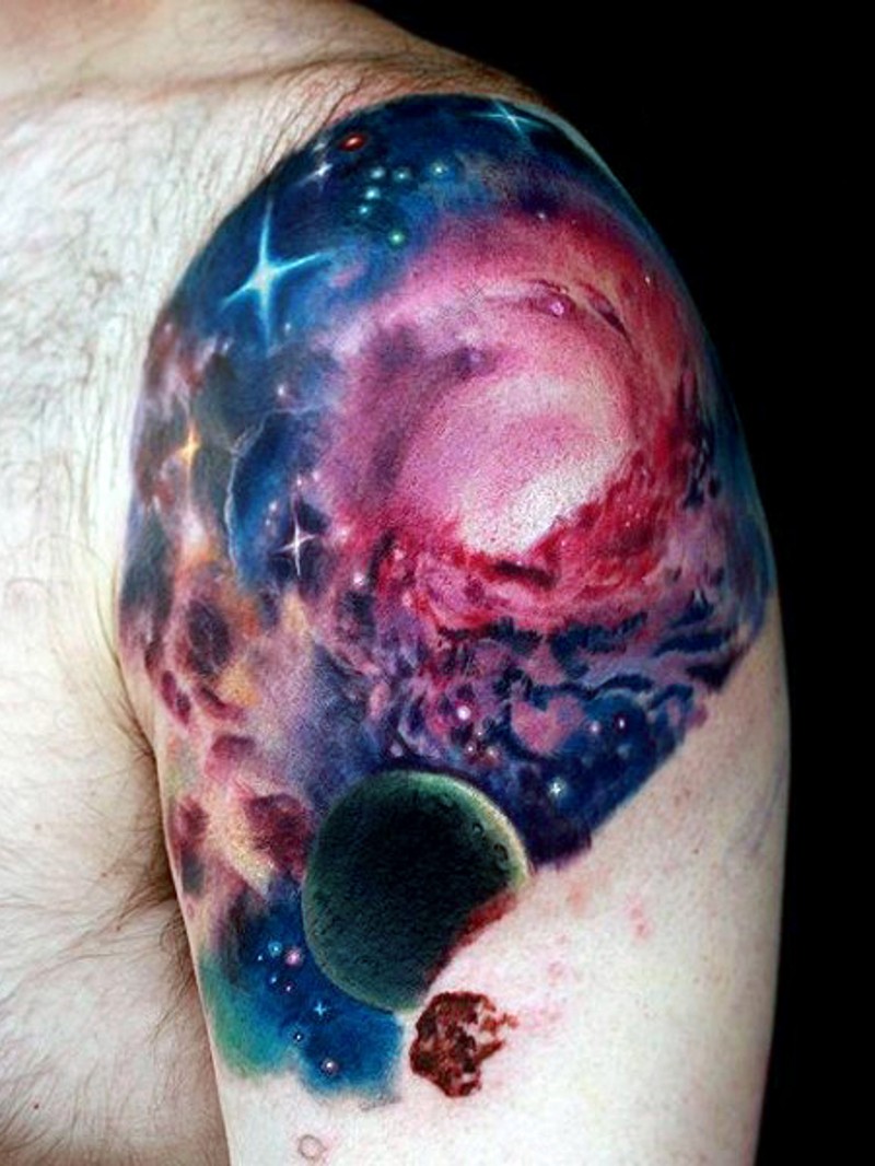 Little colored deep beautiful space tattoo on upper arm