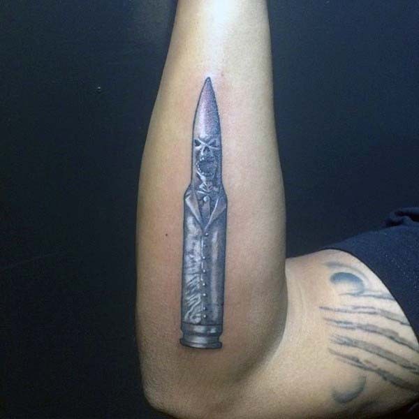 Little colored demonic bullet tattoo on arm