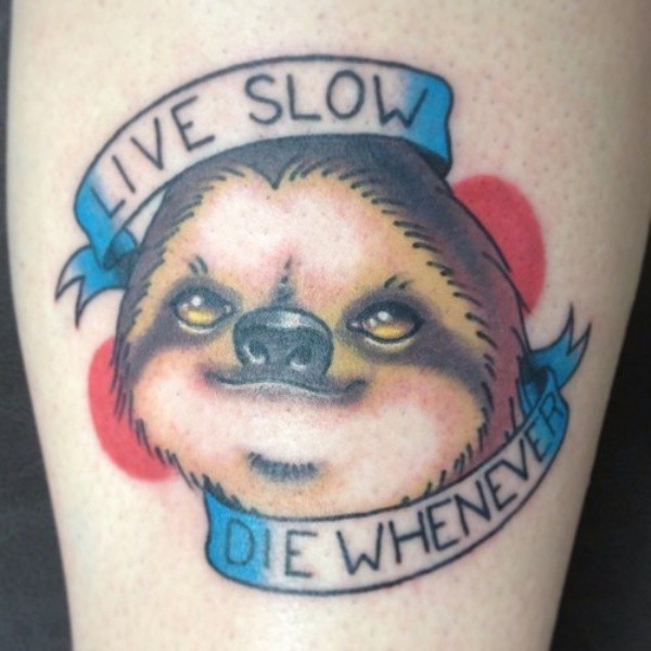 Little colored funny sloth with lettering tattoo on arm