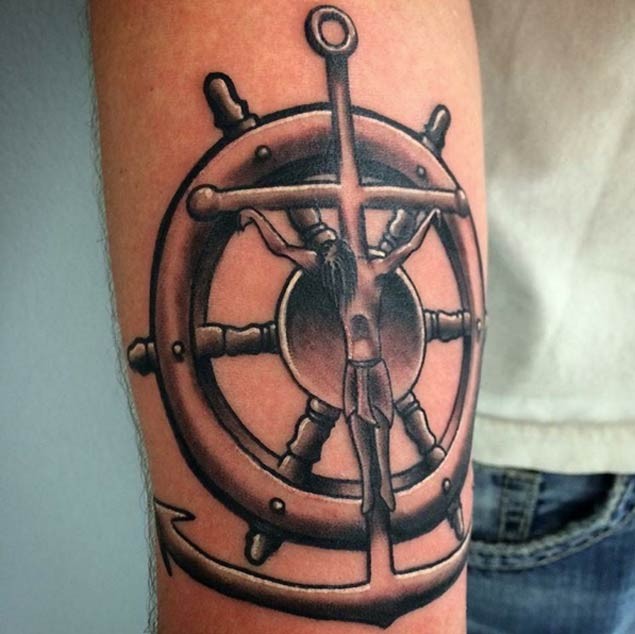 Little colored nautical themed forearm tattoo of anchor with steering wheel