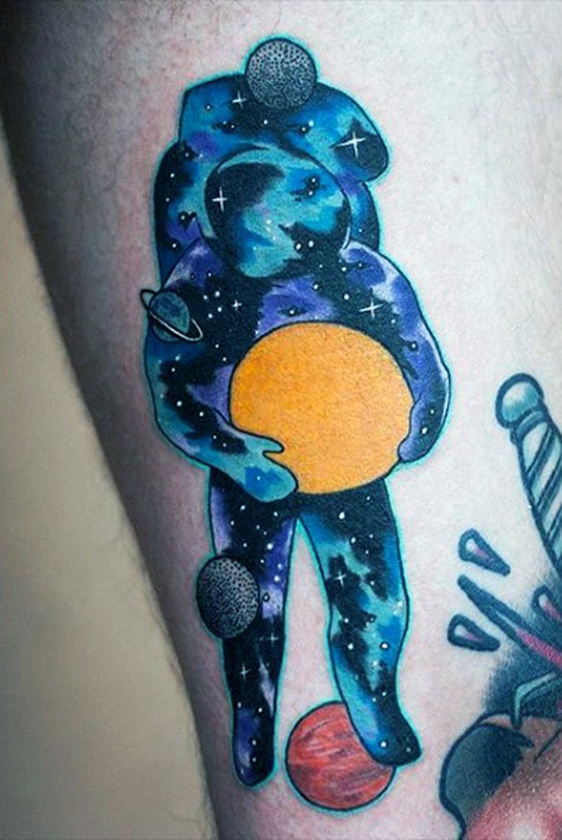Little colored spaceman stylized with solar system tattoo on arm