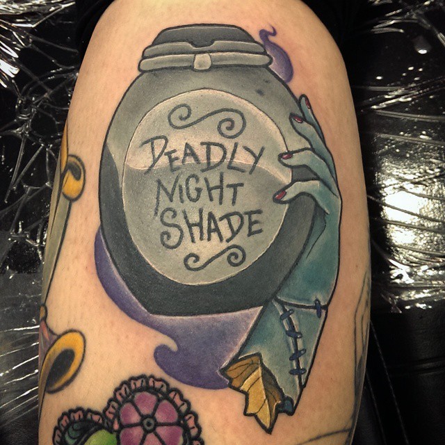 Little colored zombie hand with jar tattoo stylized with lettering