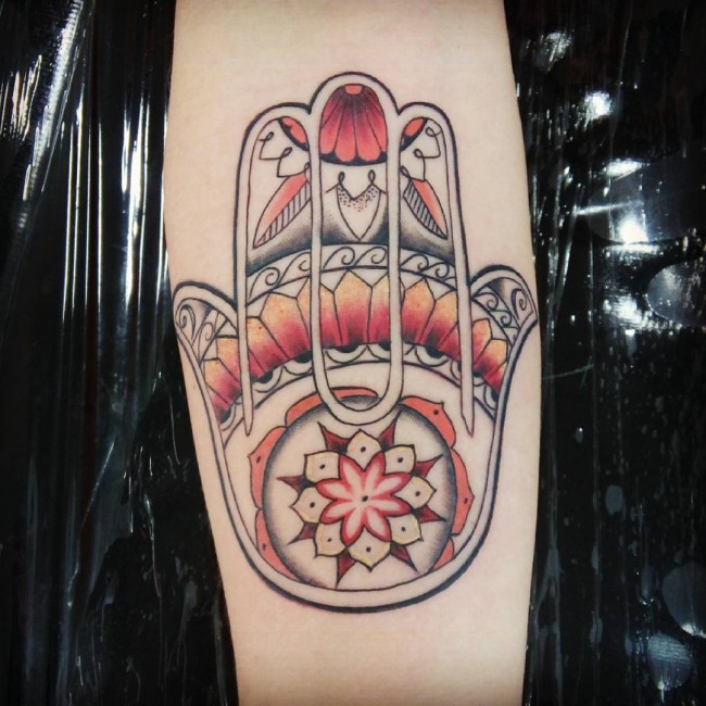 Little colorful forearm tattoo of Hamsa hand symbol