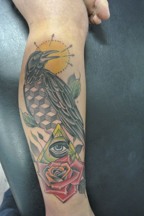 Little cult style colored crow tattoo on leg with mystic pyramid and rose