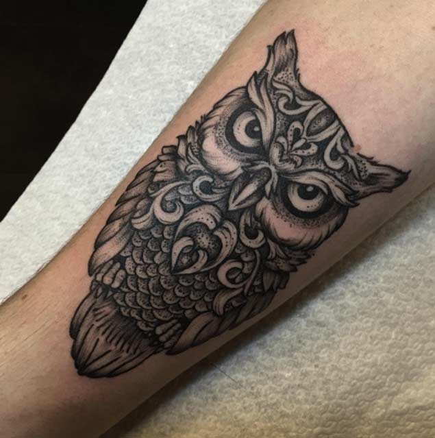 Little detailed colored creepy owl tattoo on forearm