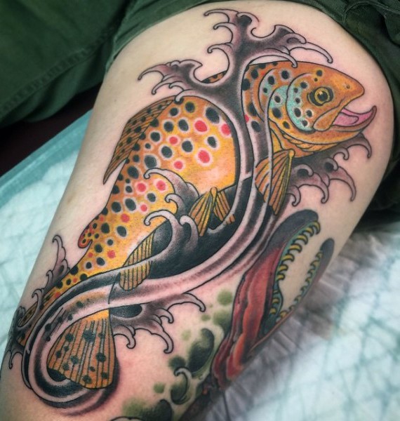 Little funny colored fish in waves tattoo on thigh