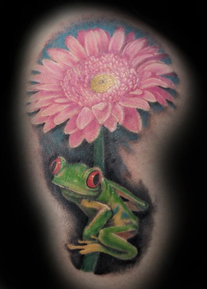 Little green frog sitting on a pink flower tattoo