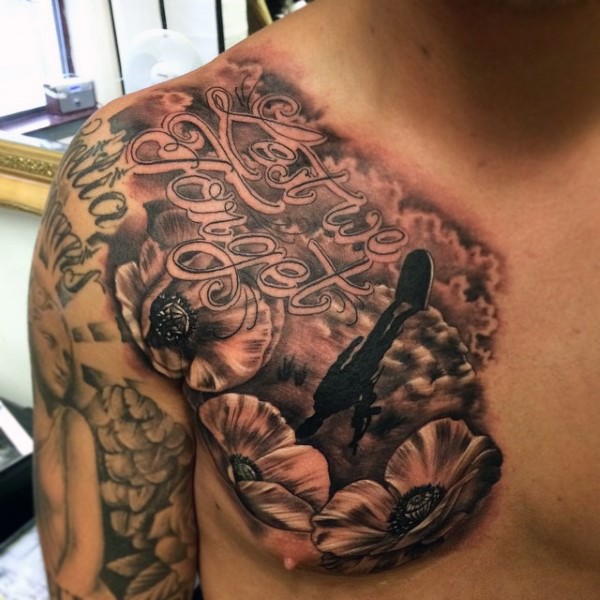 Little memorial style black and white tattoo with lettering, flowers and tombstone on chest