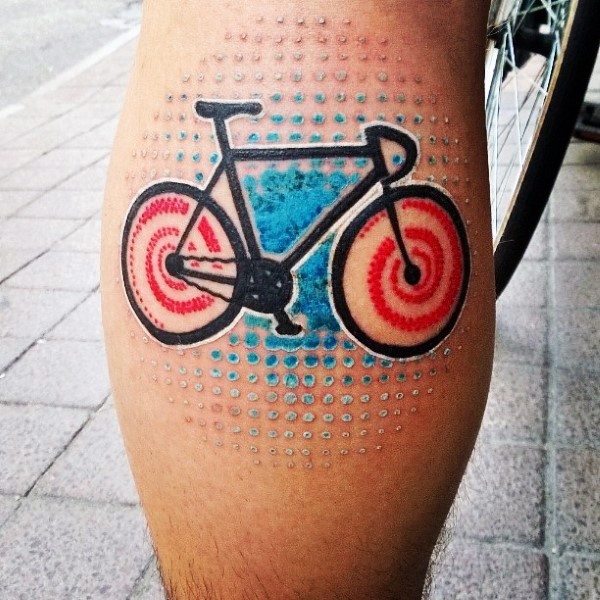 Little multicolored funny bicycle tattoo on leg