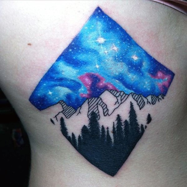 Little multicolored mountains with night sky tattoo on side