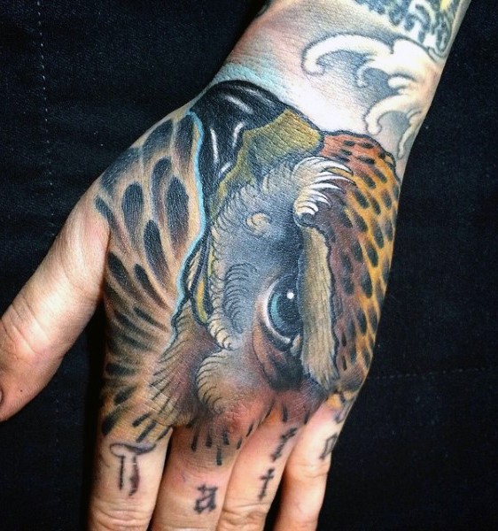 Little natural colored eagle head tattoo on hand