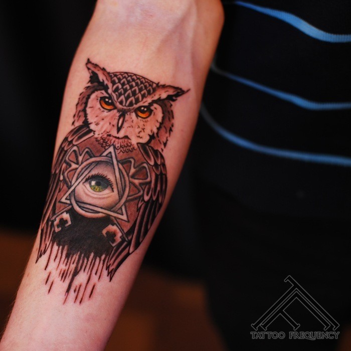 Little natural colored owl with Masonic pyramid tattoo on arm