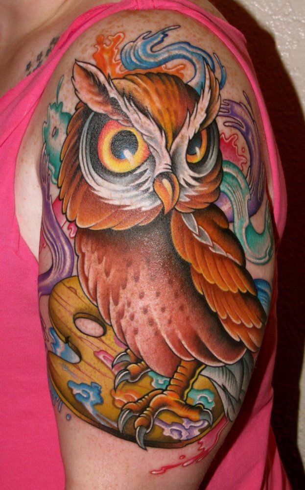 Little nice looking colorful owl tattoo on shoulder with watercolor paints