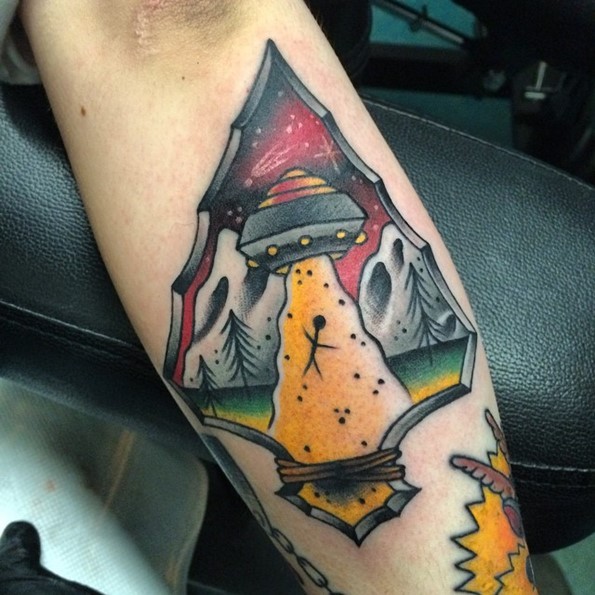 Little old school colored interesting forearm tattoo of antic weapon with alien ship