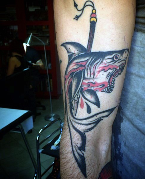 Little old school colored shark with harpoon tattoo on arm