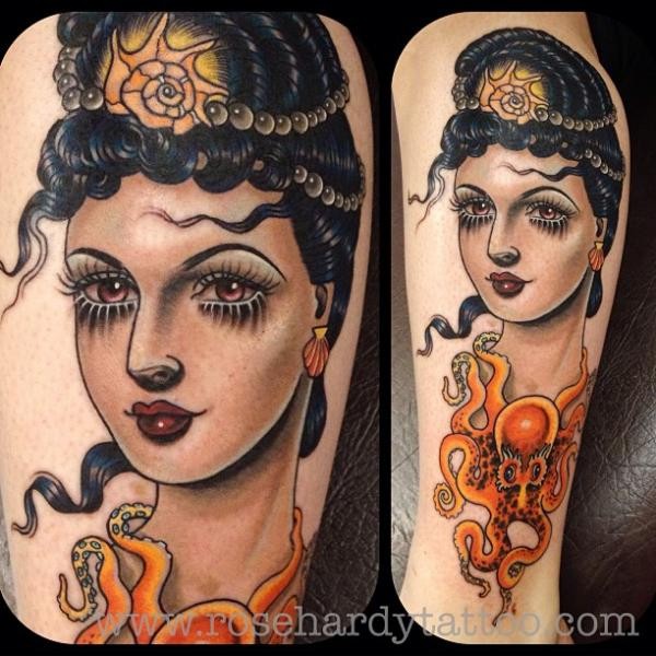Little old school style beautiful woman portrait tattoo on leg stylized with octopus