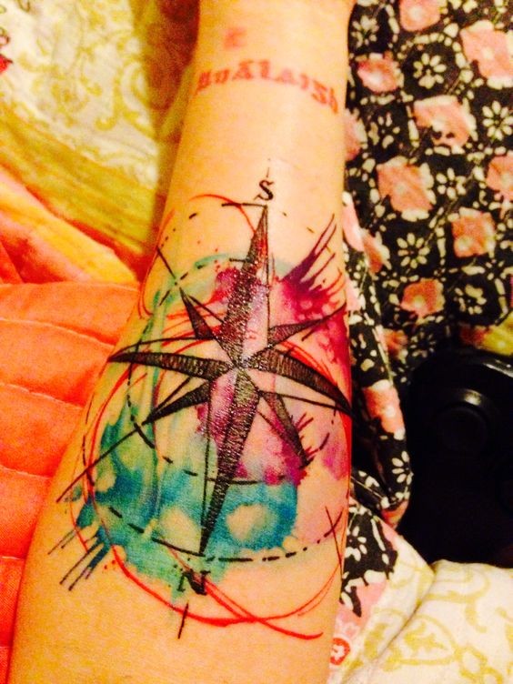 Little watercolor like nautical star tattoo on arm