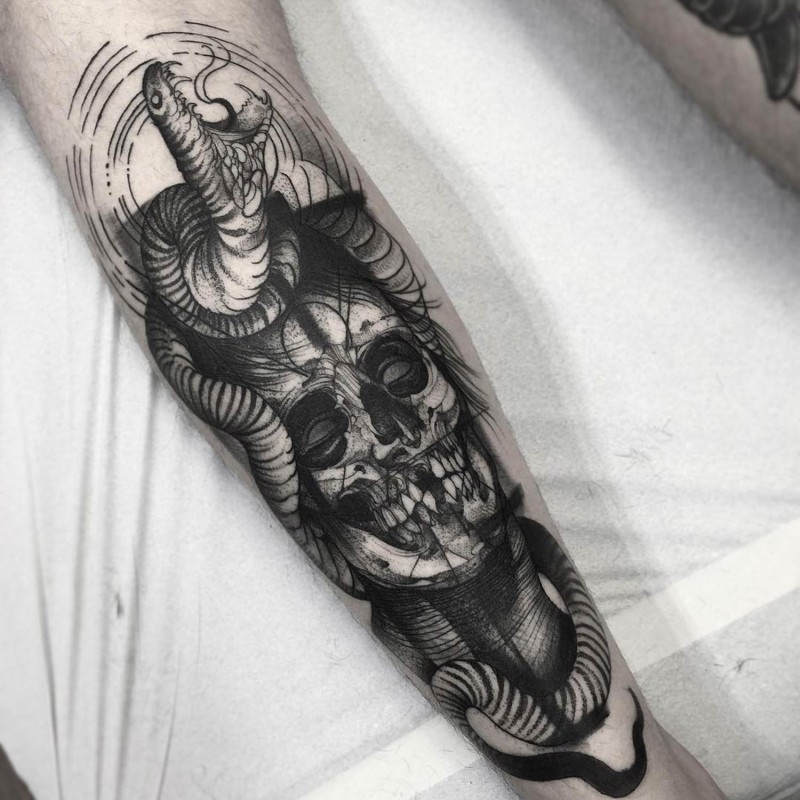 Long black ink corrupted skull tattoo on forearm combined with angry snake