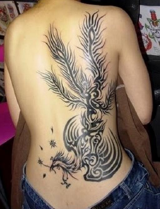 Lovely black tribal phoenix tattoo on ribs