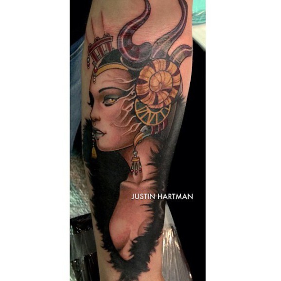 Lovely colored very detailed forearm tattoo of evil witch with nice earrings