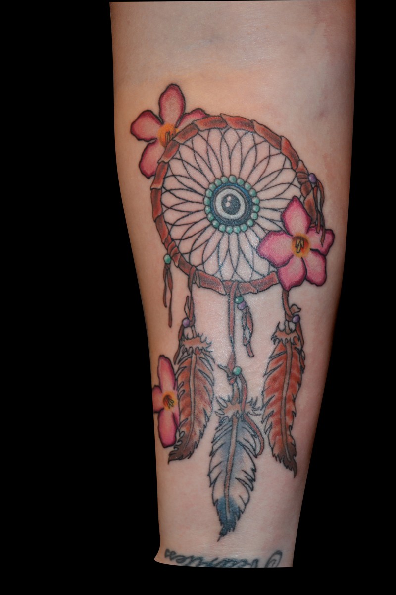 Tatuaje en el antebrazo, atrapasueños con flores diminutas
