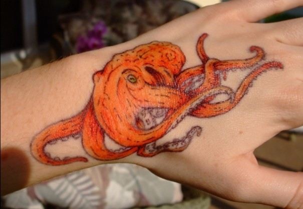 Lovely orange octopus tattoo on hand