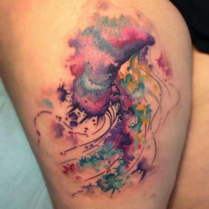 Lovely watercolor jellyfish tattoo on thigh